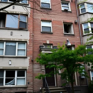 Exterior view of a deteriorating public housing building in Boston