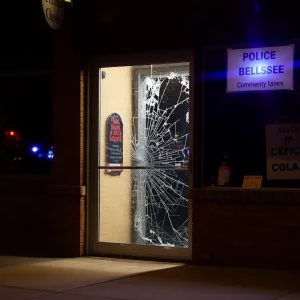 Scene of a broken door at a local Boston business with police presence.