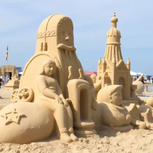 People admiring intricate sand sculptures at Revere Beach