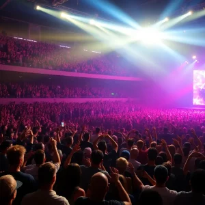 Fans enjoying a concert at an arena with colorful lights