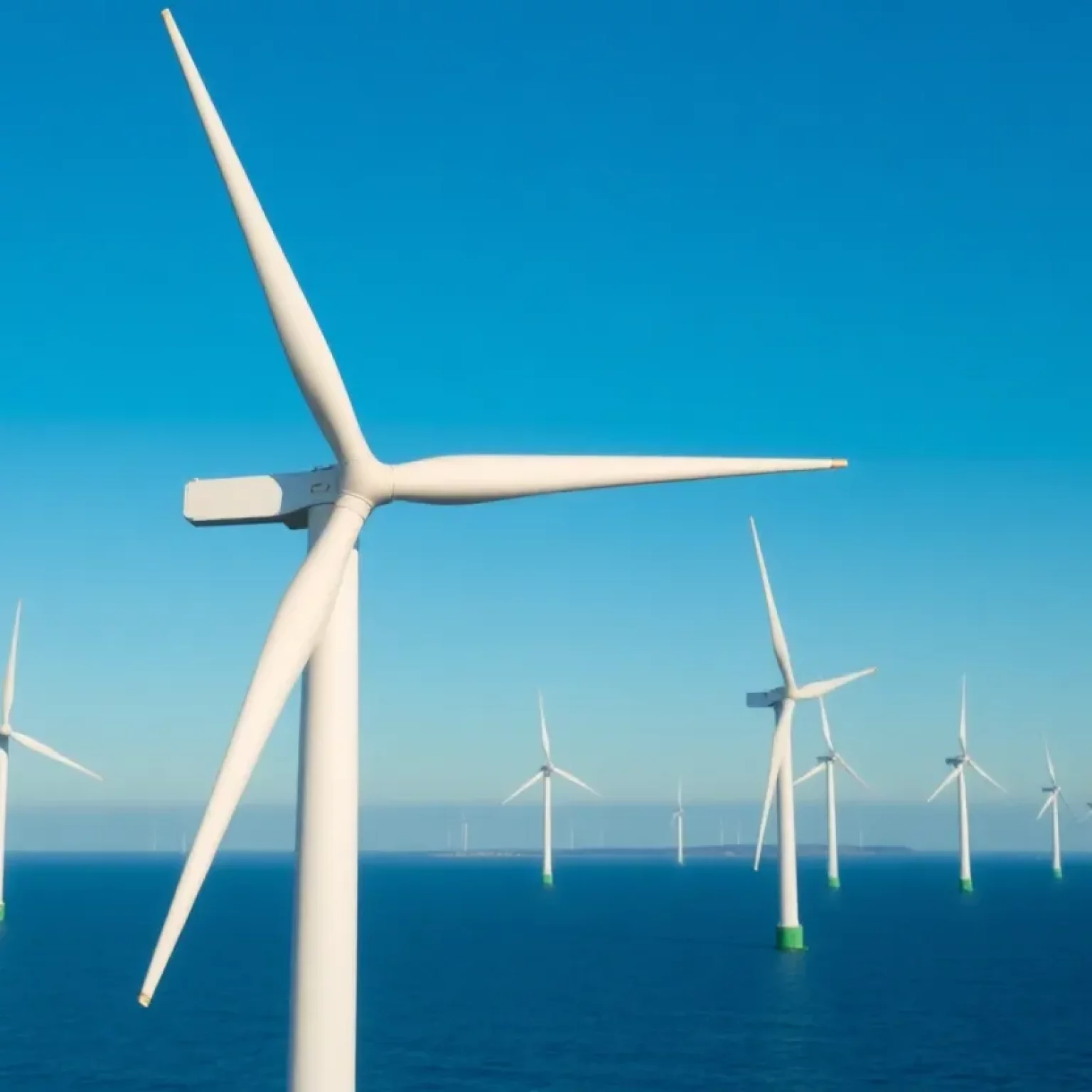 Wind turbines off the Massachusetts coast against a clear sky