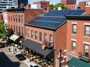 Boston street featuring renewable energy sources and happy residents.