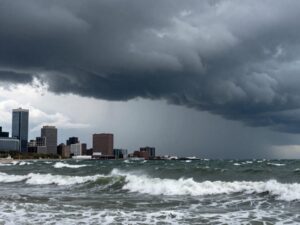 Dark storm clouds over Boston coastline with turbulent waters