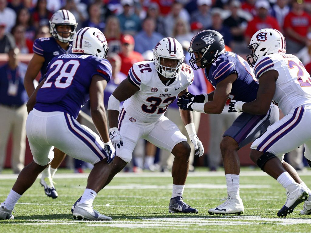Boston College football team demonstrating teamwork on the field